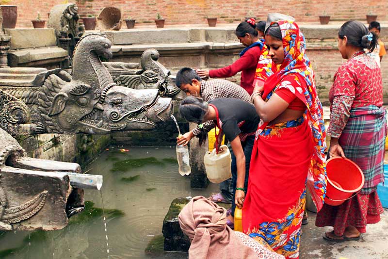 Collecting Fresh Water at a Fountain in the Historic Durbar Square Area of Patan, Nepal