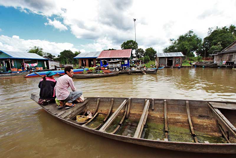 Cruising Past Floating Houses on Tonle Sap River During a Boat Ride to Siem Reap, Cambodia