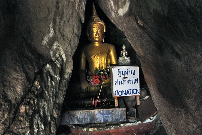 Small Buddha statue tucked in the far corner of a cave on Khao Takiab Hill
