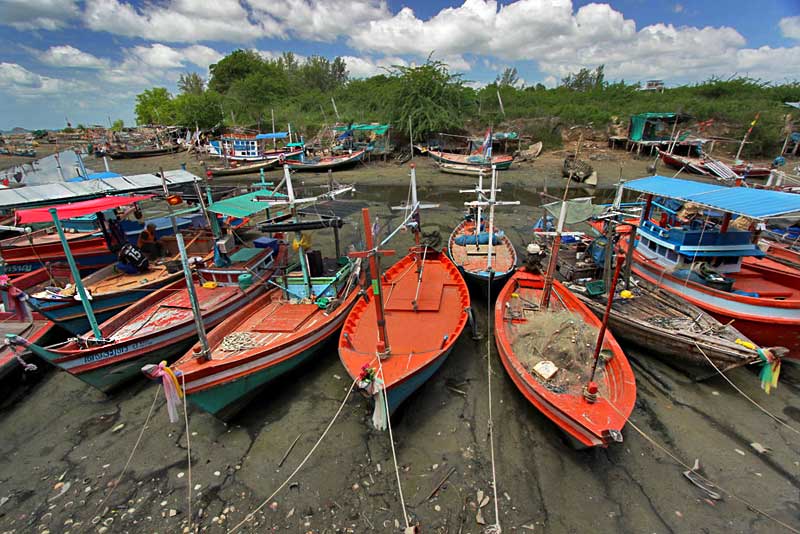 Beached Fishing Boats in Hua Hin, Thailand, Wait for High Tide