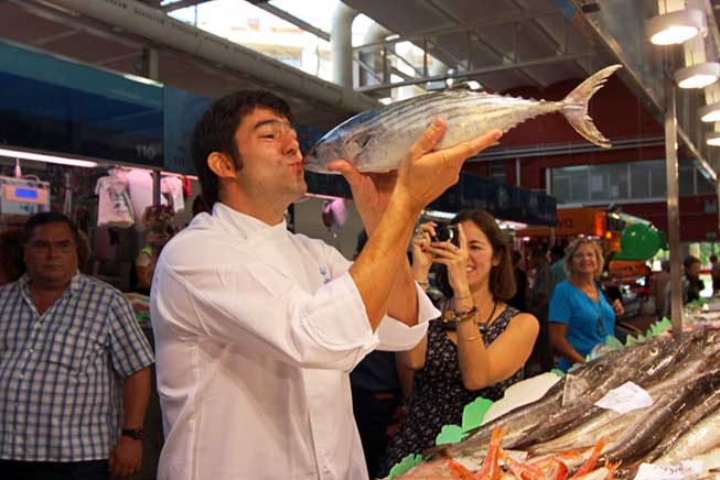 Chef Xavier Arrey kisses a beautiful fresh-caught bonito destined for our cooking class and, later, our dinner table