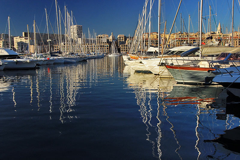 Masts Ripple in Reflective Waters of Harbor at Vieux Port in Marseille, France