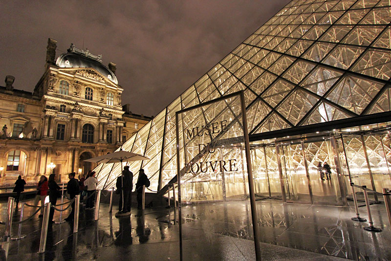 Illuminated Glass Pyramid at the Louvre Museum in Paris, France