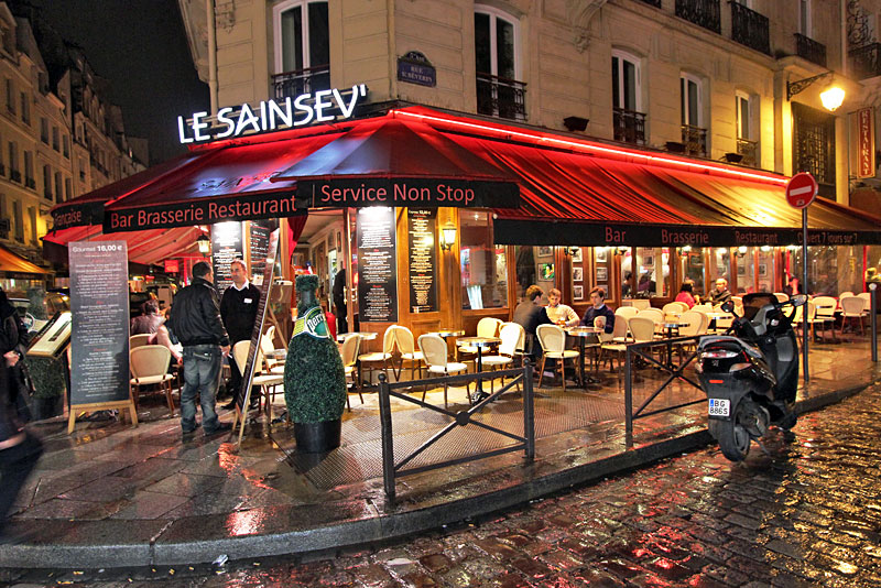 Rain-Soaked Corner Cafe on the Left Bank of Paris, France