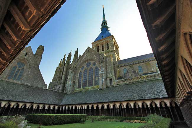 Spire of Mont Saint Michel looms over the cloister, Normandy France