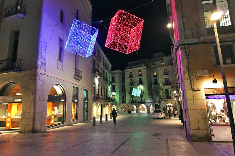 Christmas Decorations Hang Above a Pedestrian Shopping Street in the Old Town of Girona, Spain