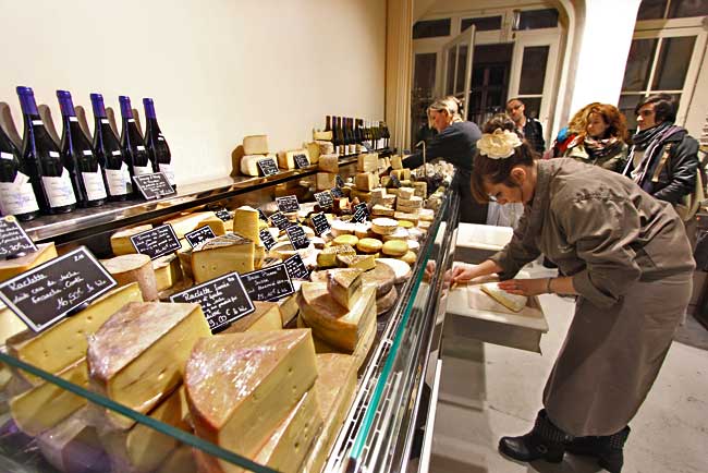 Harder cheeses are displayed in one case at Fromagerie Deruelle gourmet cheese shop in Bordeaux, France