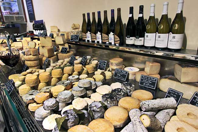 Harder cheeses are displayed in one case at Fromagerie Deruelle gourmet cheese shop in Bordeaux, France