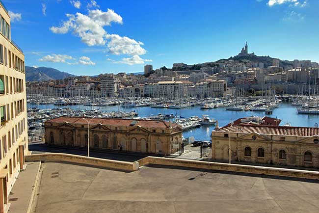 North side of Le Vieux Port, looking back toward Notre Dame de la Garde Basilica, which keeps a protective eye on Marseille France