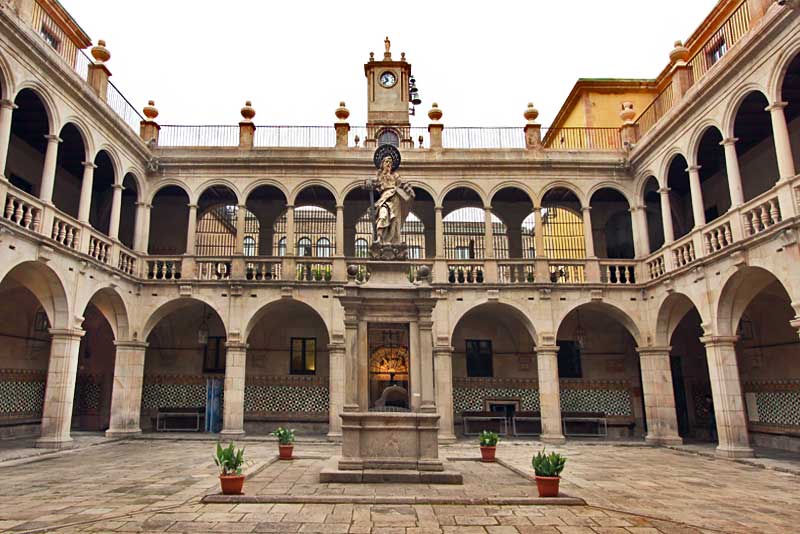 Inner Courtyard of Old Monastery and Hospital in the Raval District of Barcelona, Spain Features Arches and Moorish Tiles