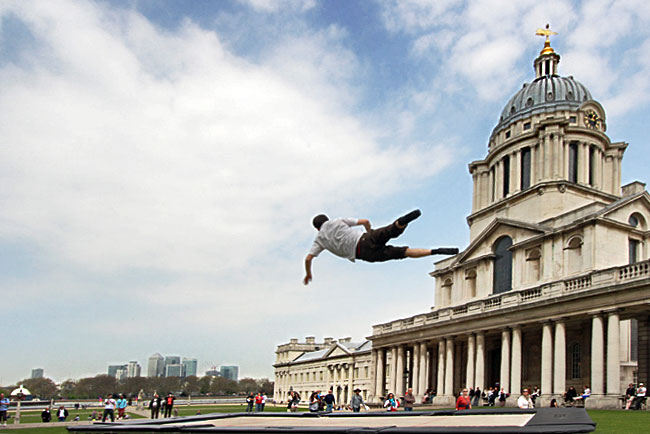 Trampoline artist appears to climb the walls of the Old Royal Naval College in Greenwich London