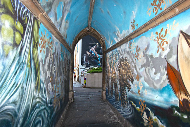 View through painted pedestrian tunnel frames street painting of a matador slaying a bull