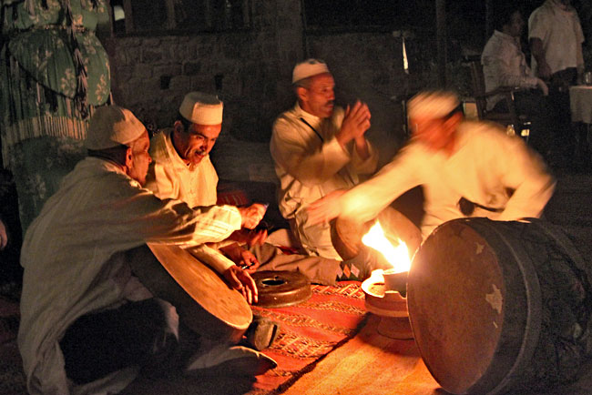 Prior to performing, Berber Musicians warm up their drums before an open fire in the Ourika Valley