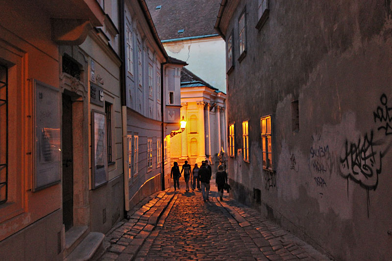 Golden Light From Lanterns Washes Over a Typical Cobblestone Street in Bratislava, Slovakia