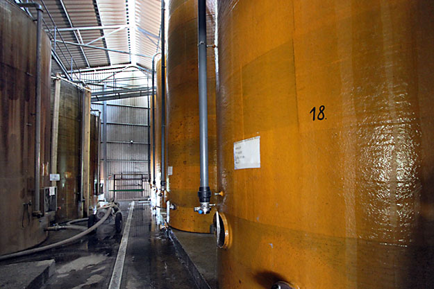 Cool water runs down the outside of Hungarian Palinka fermentation tanks to keep the mash from overheating