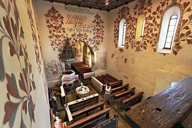 Seventeenth-century Calvinist floral motifs share the walls with 13th and 14th century frescoes of saints in this Medieval church in Csaroda, Hungary