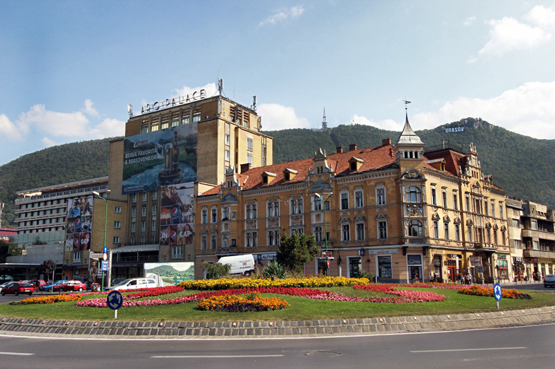 Giant Sign Atop Forest-clad Mountains Overlooks Historic Buildings in Brasov, Romania