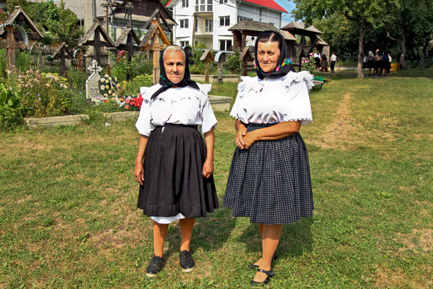 Two women in traditional dress pose for me after attending service at the new church