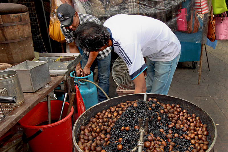 Roasting Chestnuts on Petaling Street in Chinatown in Kuala Lumpur, Malaysia
