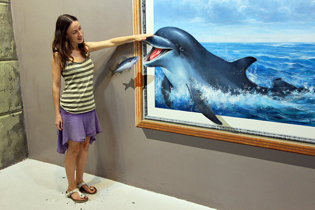 Paola pets a dolphin at Art in Paradise in Chiang Mai, Thailand