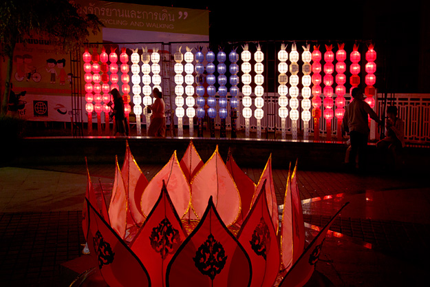 Lanterns and giant paper lotus blossoms decorate the sidewalks of the Old Town in Chiang Mai during Yi Peng