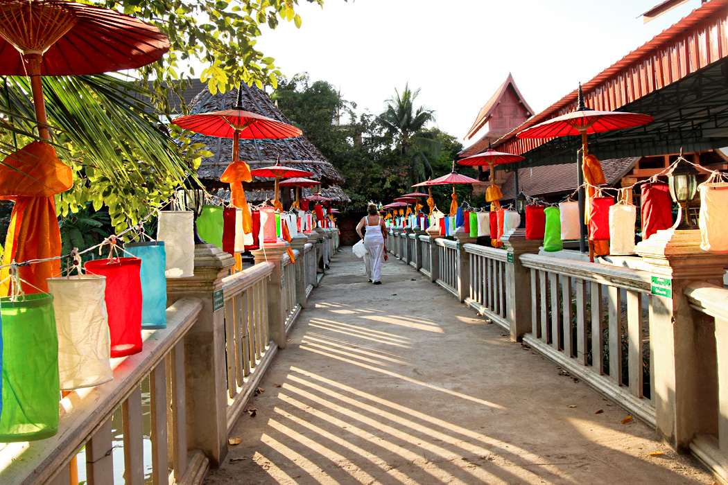 Lanterns and umbrellas decorate walkway to monks' quarters at Wat Jetlin in Chiang Mai, Thailand