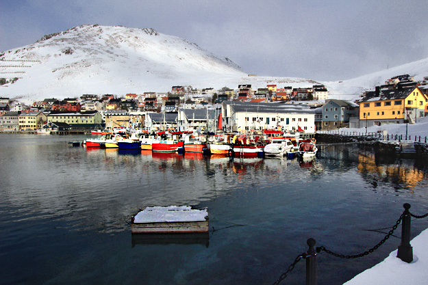 Boats and houses add color to the white-on-white landscape