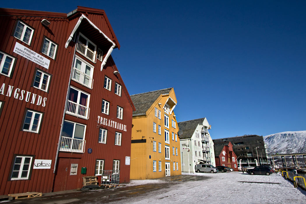 Colorful buildings on the harbor in Tromso, Norway enliven a snowy landscape