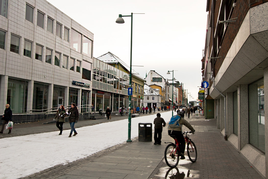 Storgata Street, the main pedestrian mall in Tromso, Norway, is full of people despite the weather