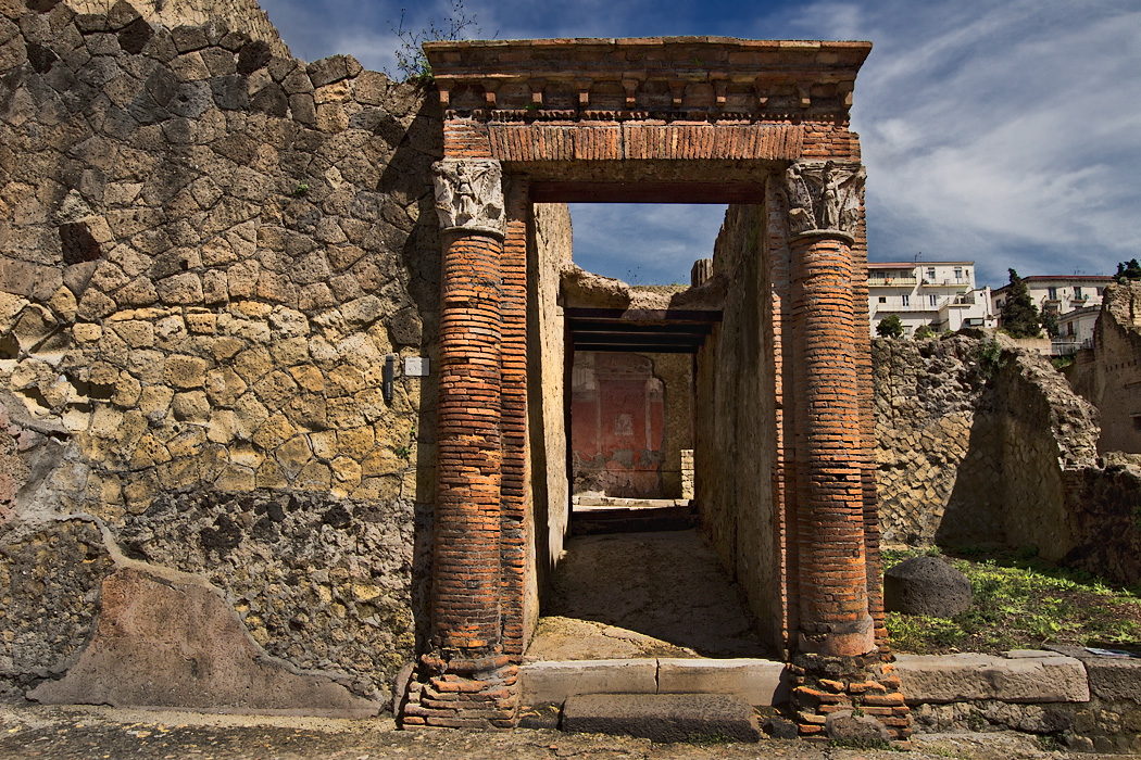 Magnificent portal at Herculaneum leads to stunning wall frescoes in ruined house