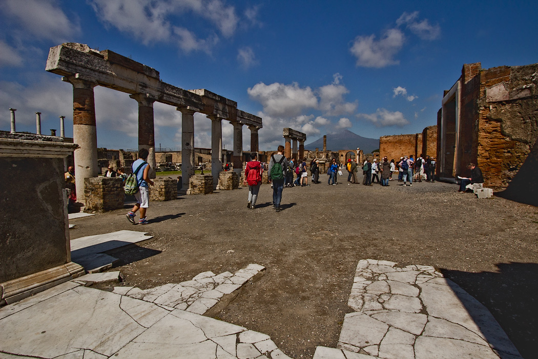 The Forum of Pompeii, a large market area surrounded by the most important buildings in the town. Shown in the foreground are remains of the travertine paving that once covered the entire square