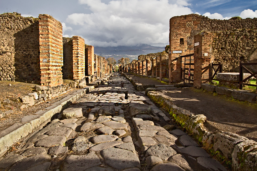 Typical Pompeii street with wheel ruts carved deeply into the stone pavement