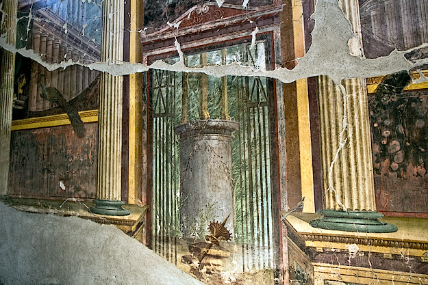 Detail of frescoes in the living room at Villa di Poppaea. Shown here is the tromp l'oeil pedestal column with sacrificial tripod, seen through a false door leading to a sanctuary dedicated to Apollo and family ancestors