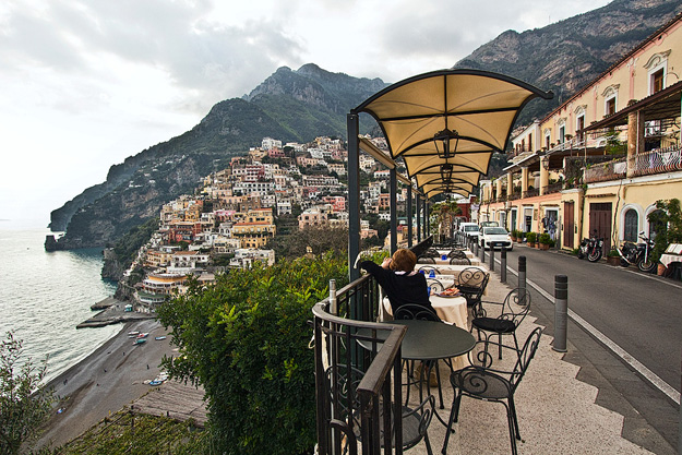 At sunset, buildings flow to the sea like liquid gold in Positano, Italy