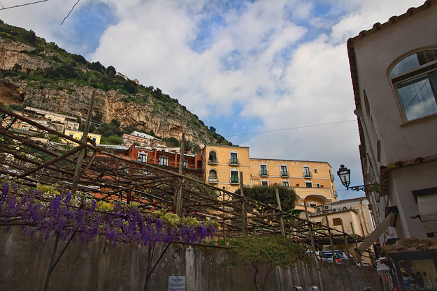 Setting sun splashes mountaintop buildings in Positano, Italy