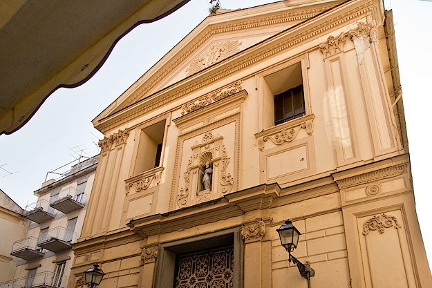 Statue of the Bishop of Baccolo, who drove the devil out of the church, stands in an alcove in the facade of the Church of Saints Felix and Baccolo, also known as Church of the Rosary