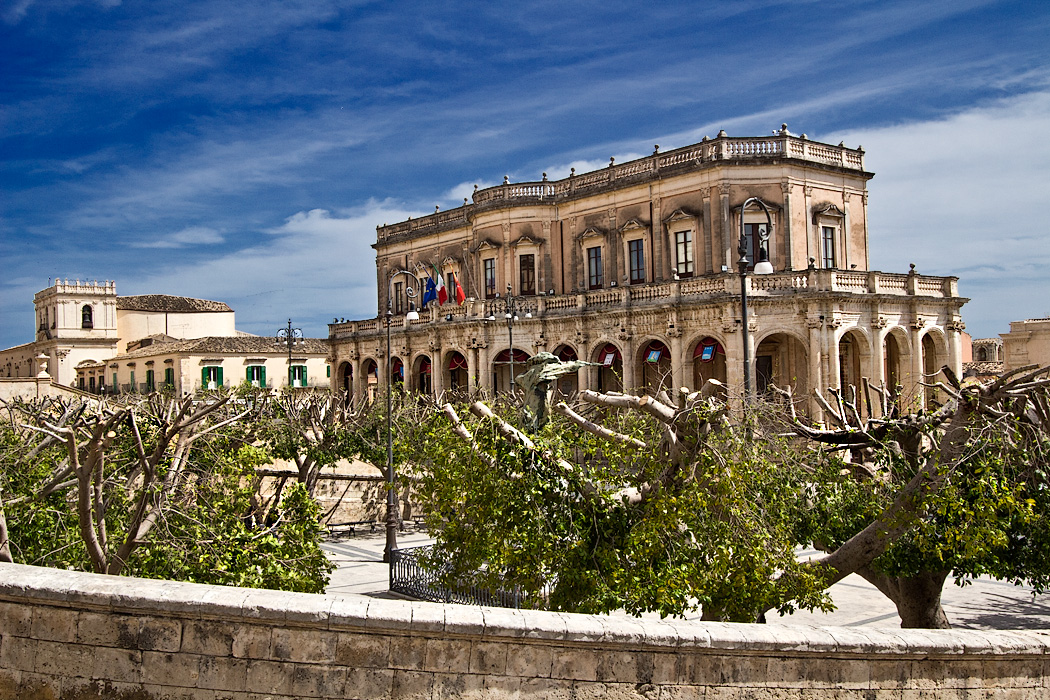 Municipio (Town Hall) in the Baroque town of Noto, one of three towns that were entirely rebuilt on new sites after the earthquake of 1693. Buildings were constructed of a local limestone that glows a soft honeyed gold color at sunset.