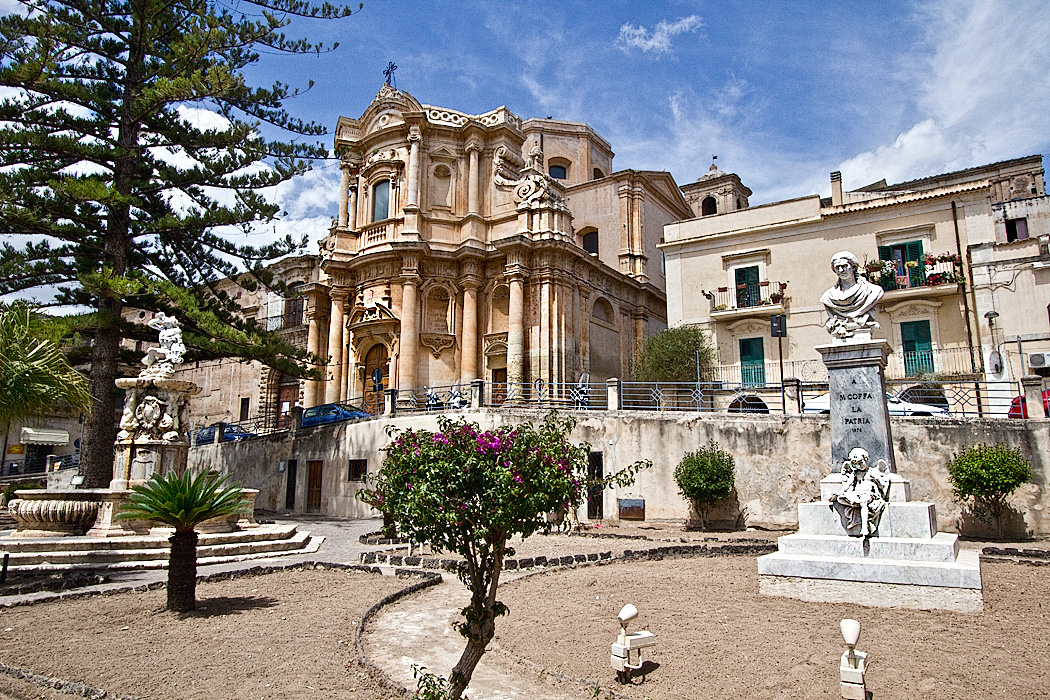 Church of San Domenico and magnificent Fountain of Hercules are the centerpieces of Piazza XVI Maggio, located near the western end of Corso Umberto Vittorio, the main thoroughofare in the Baroque town of Noto, Sicily.