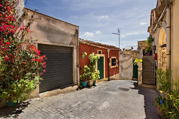 Colorful houses on a street in the Quartiere Agliastrello in Noto, Sicily