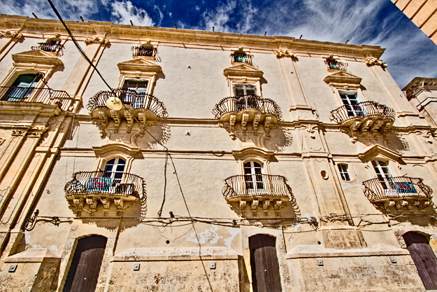 Honey-colored tufa stone used to construct the Baroque buildings in Noto, Sicily, glows golden at sunset