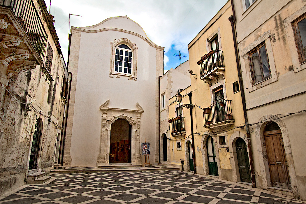 Typical neighborhood square in the medieval Old Town of Syracuse, Sicily, which is located on the Island of Ortigia, the historical heart of Siracusa.