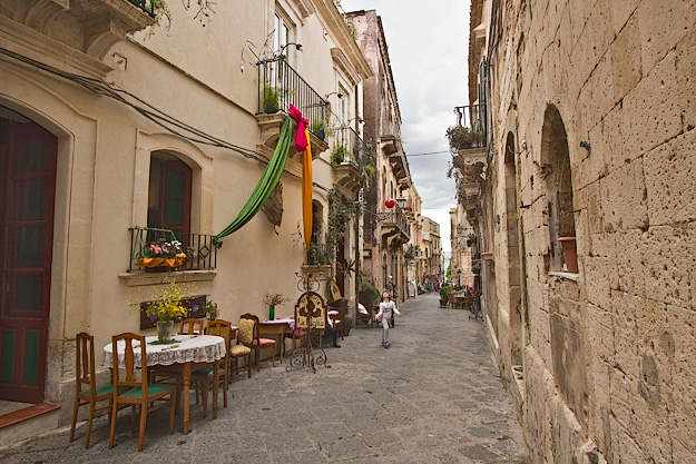 Sidewalk cafes are scattered throughout the narrow cobblestone streets in the Syracuse's Old City