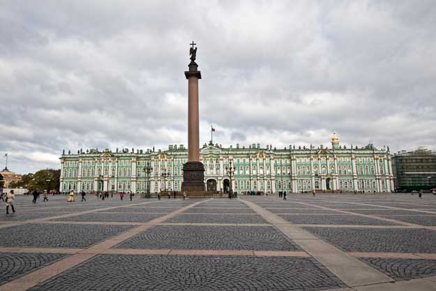 Alexander Column stands in the center of Palace Square, behind which looms the ornate Winter Palace, which today houses the Hermitage Museum