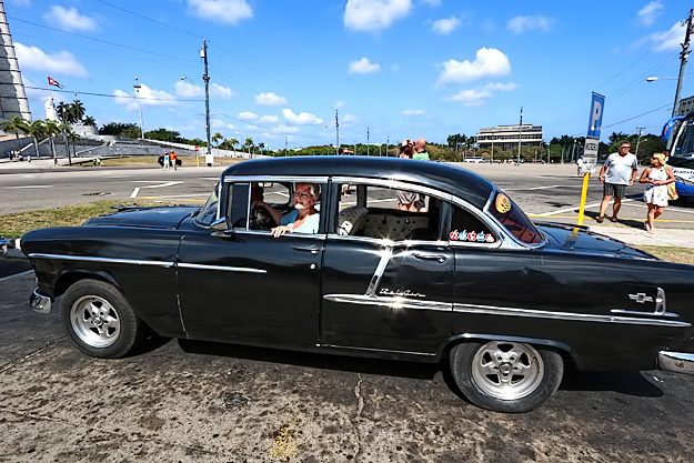 Sitting in a 1955 Chevy Bel Air, now a classic taxi in Havana, Cuba