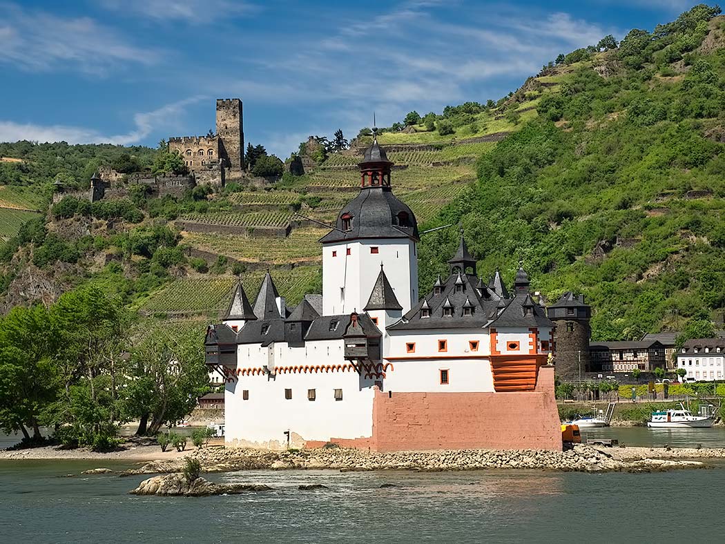 In the MittelRhein area of Germany, the hilltop Gutenfels castle overlooks Pfalzgrafenstein Castle, perched on a rock in the middle of the Rhine River