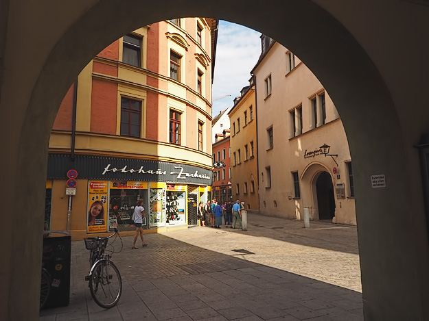 Archway in Regensburg, Germany frames pretty city street