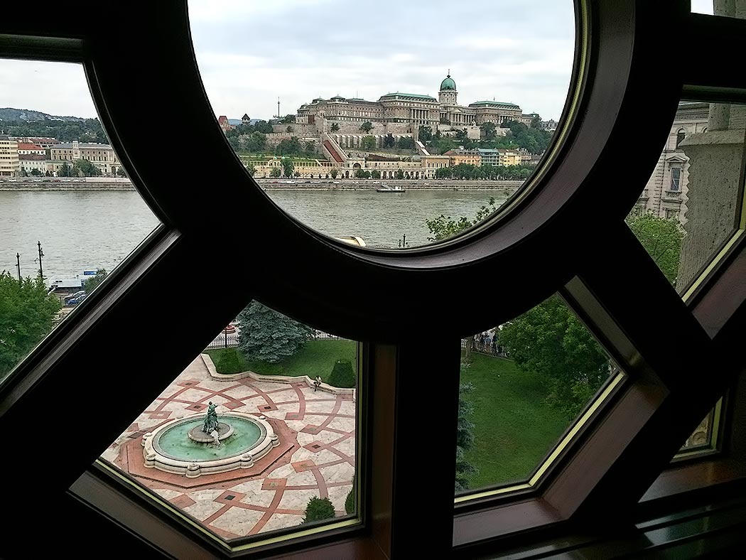 Budapest Castle on the Buda side of the city, seen through a window of the newly restored Vigado Palace on the Pest side