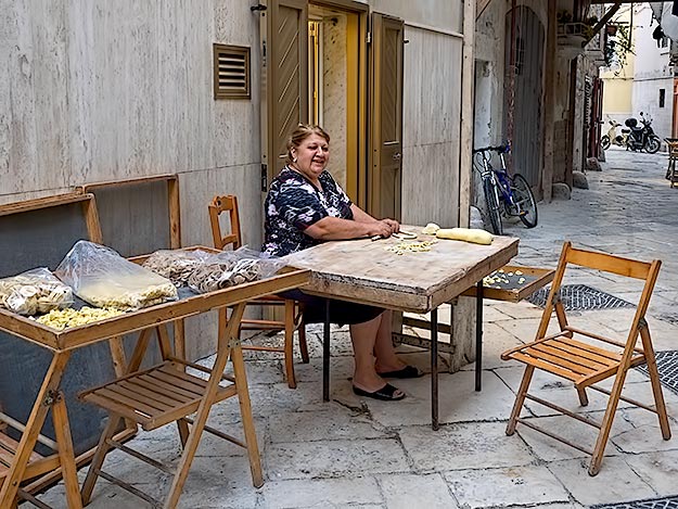 Woman in Bari, Italy makes pasta by hand without even watching what she is doing