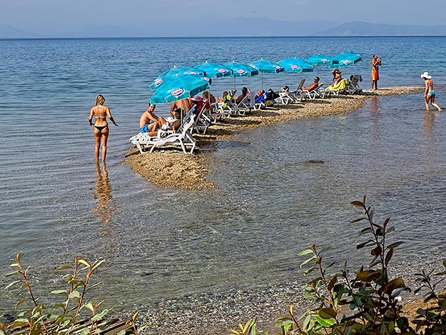 Beachgoers on a day trip to St. Naum occupy a sandbar in Lake Ohrid