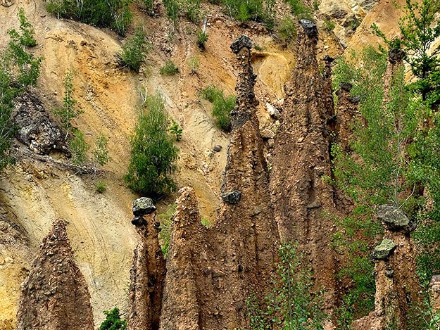 Devil's Town in Serbia showcases a geologic formation that occurs when water and wind erode the softer soil below a harder, impervious layer of stone
